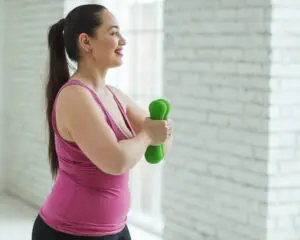 Woman lifting weights after weight loss surgery.