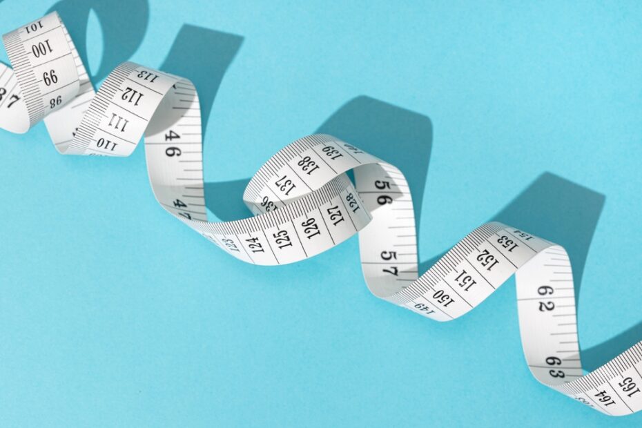 Measuring tape on blue background.